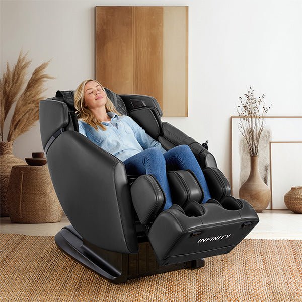 A woman relaxing in the Infinity Riage 4D Massage Chair, featuring advanced 4D back mechanism and luxurious materials for a professional massage experience.