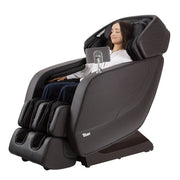 A woman sitting in the Titan Jupiter LE Premium Massage Chair, showcasing its ergonomic design and advanced massage features.