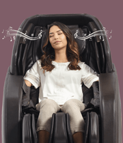 A woman relaxes in a Daiwa Hubble Massage Chair, surrounded by musical notes, eyes closed, enjoying features like Zero Gravity recline and 48 airbag massage.