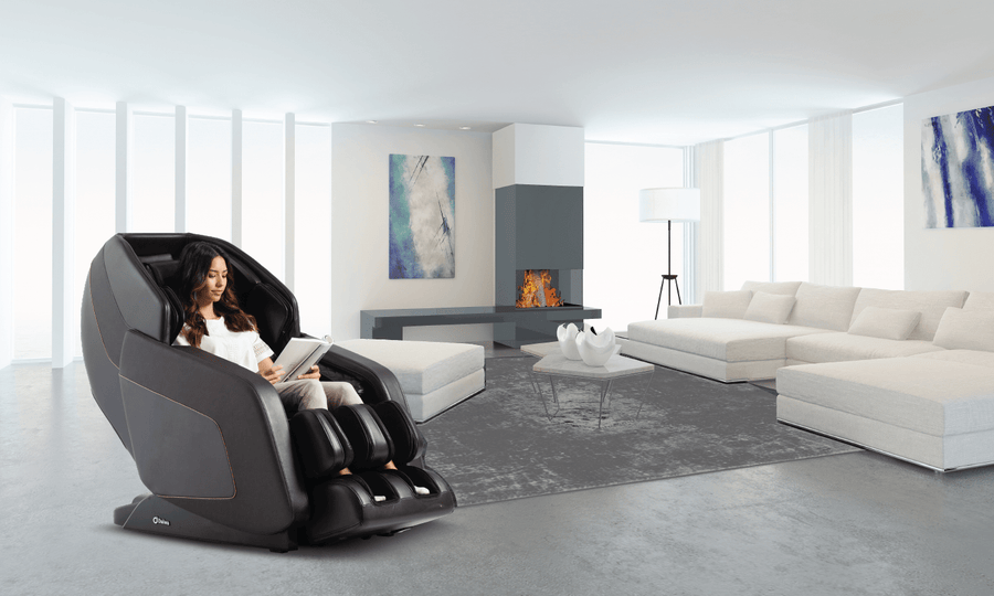 A woman sits in a Daiwa Hubble Massage Chair in a living room, showcasing its ergonomic design and features.