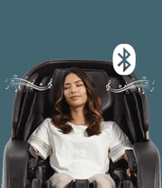 A woman enjoying a relaxing session in the Daiwa Legacy 4 Massage Chair, eyes closed, highlighting its advanced comfort features.