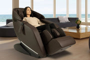 A woman reclining in the Kyota Genki M380 Massage Chair, featuring advanced massage technology for full-body relaxation.