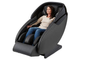 A woman relaxing in a Kyota Kaizen M680 Massage Chair with eyes closed, highlighting full-body massage features.