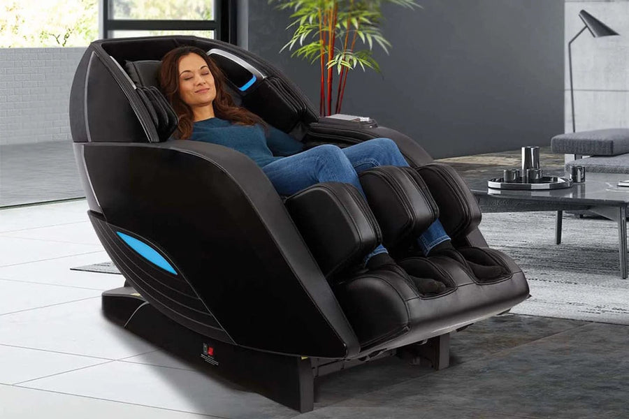 A woman lies in the Kyota Yutaka M898 Massage Chair, receiving a full-body therapeutic massage.