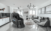 A black Medical Breakthrough 10 massage chair in a living room, designed to improve posture and reduce body pain.