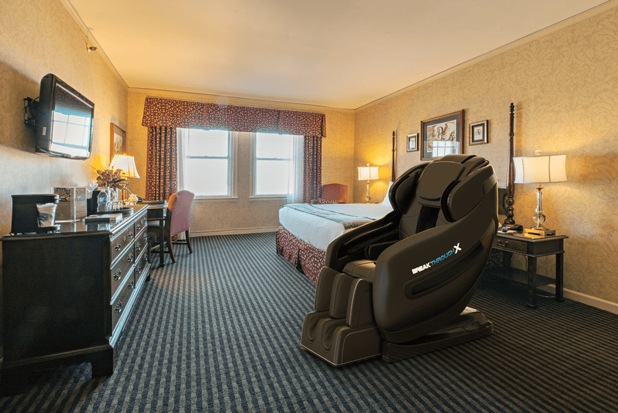 Medical Breakthrough 10 massage chair in a hotel room, designed to improve posture, reduce pain, and aid sleep with advanced therapeutic features.