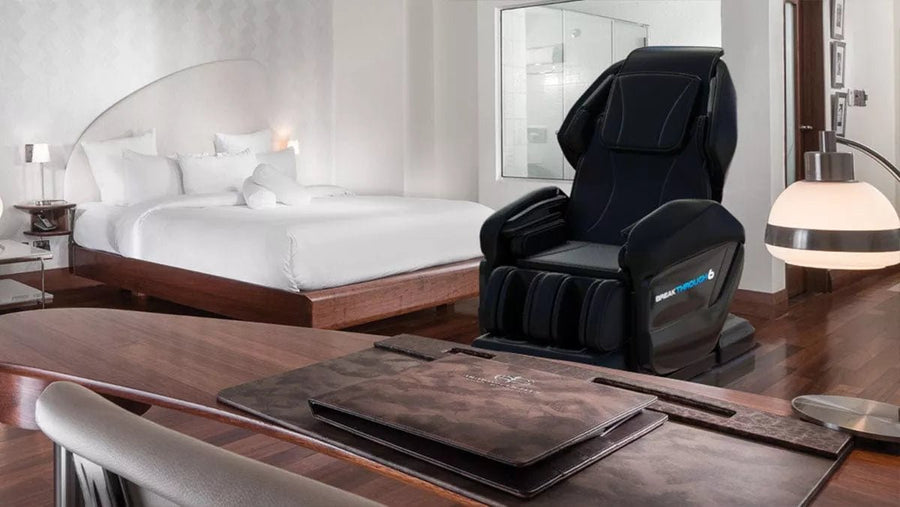 Black reclining Medical Breakthrough 6 Plus massage chair in a modern room, designed to improve posture, reduce pain, and aid sleep with advanced features.