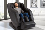 Man asleep in Sharper Image Relieve 3D Massage Chair, showcasing advanced massage features and ergonomic design for deep tissue relief and relaxation.